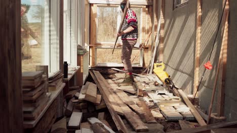 Man-Sorting-Wood-Planks,-Construction-Of-DIY-Greenhouse---Wide-Shot