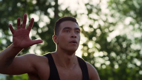 Closeup-focused-muscular-streetball-player-training-basketball-outdoor.