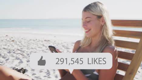 Sitting-on-beach-and-using-smartphone,-woman-with-likes-count-animation