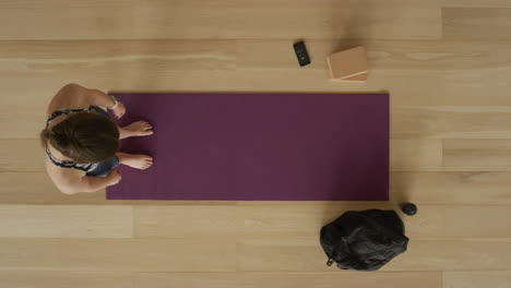 overhead view flexible yoga woman practicing stretching body enjoying healthy lifestyle exercising in fitness studio training on exercise mat