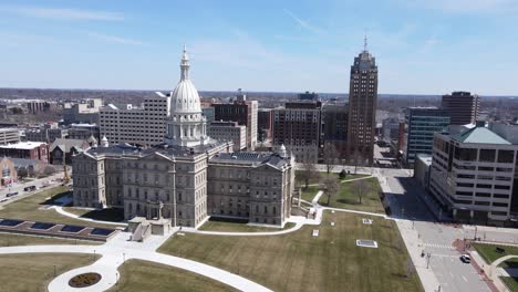 Lansing-downtown-and-majestic-Capital-building,-aerial-orbit-view