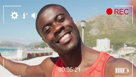 Animation-of-play-screen-over-happy-exercising-african-american-man-making-video-on-sunny-beach