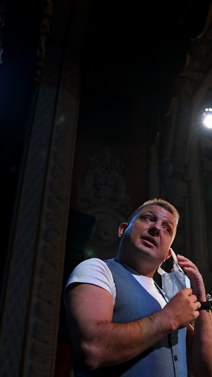 Actor in medical mask on theatre scene. Motivational Speaker. Vertical video