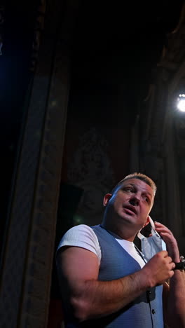 actor in medical mask on theatre scene. motivational speaker. vertical video