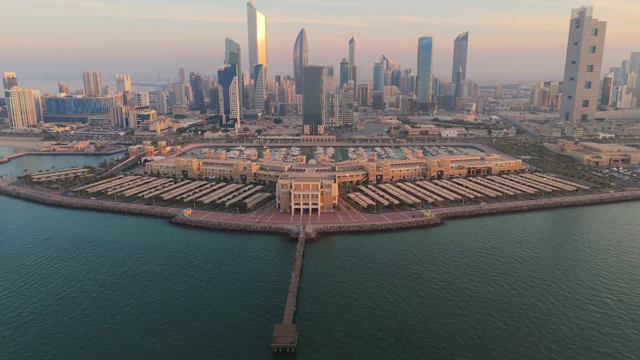 Stunning 4K drone shot of Marina Crescent in Kuwait with a golden sunrise over iconic skyscrapers and the waterfront. Perfect for tourism, architecture, and cityscape themes.