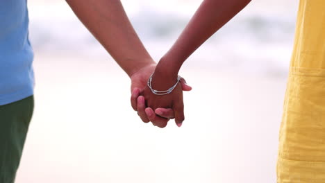 couple, holding hands and love by beach in care