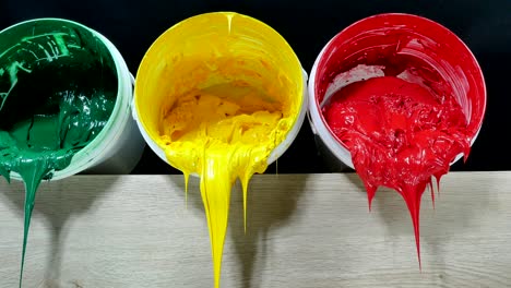 green yellow and red colors of plastisol ink in white plastic cans
