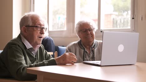 senior couple sending air kiss during video call