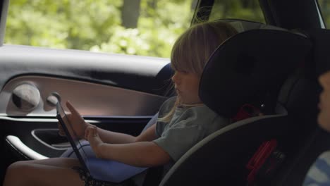 video de niños en el asiento trasero del coche con tableta