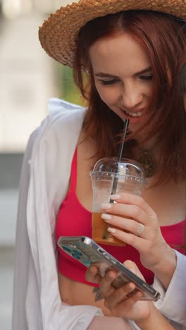 two women friends looking at a smartphone outdoors