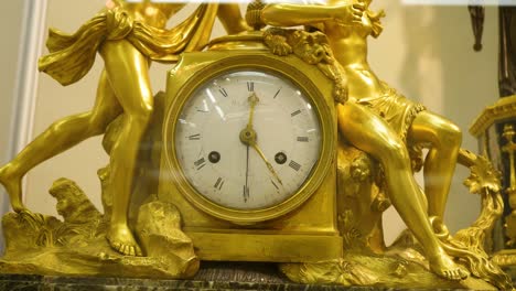 antique gold-gilded clock with classical sculptures