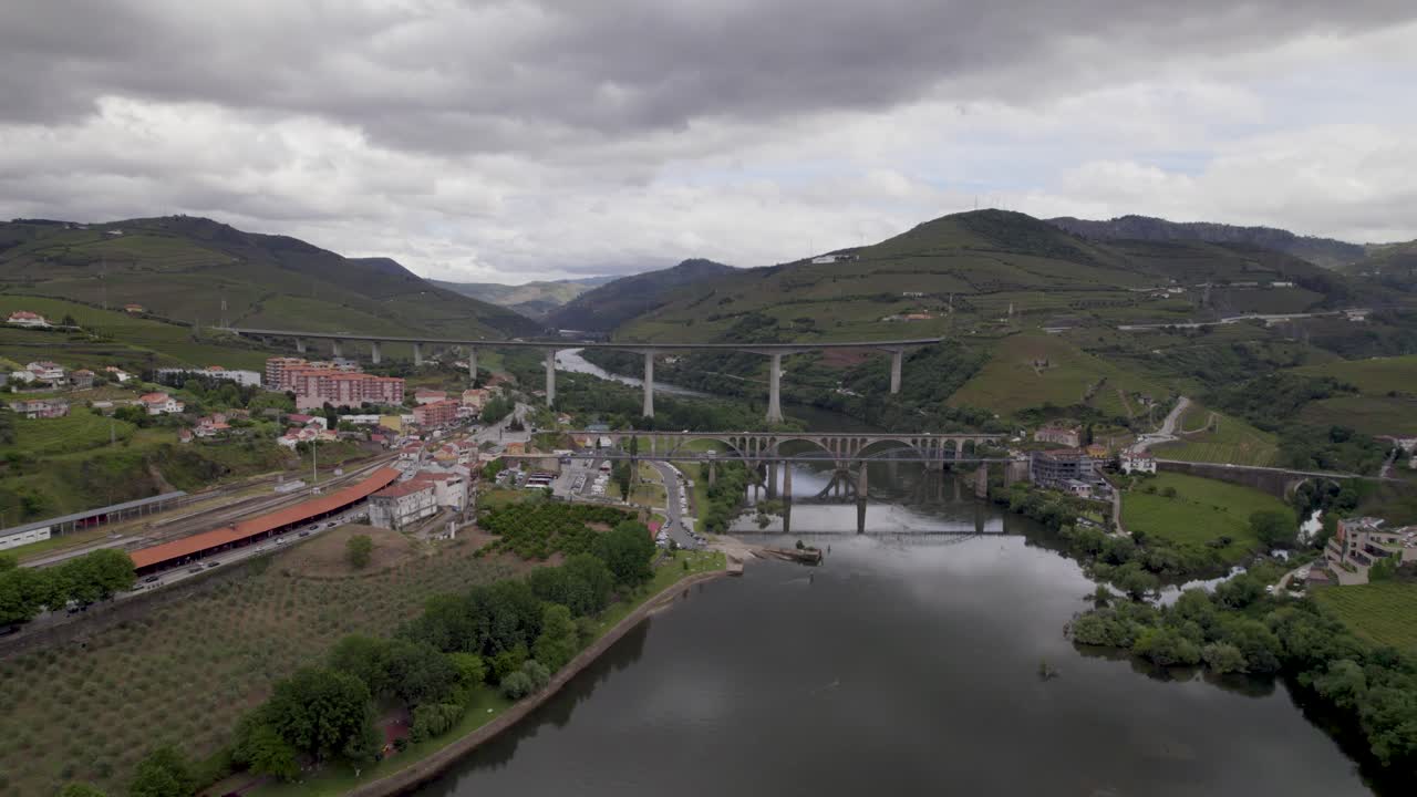 Peso da Régua in Vila Real, showing Douro River bridges and terraced vineyards in Alto Douro Vinhateiro - Aerial