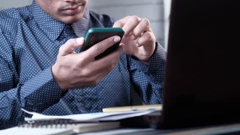 person using a smartphone at a desk