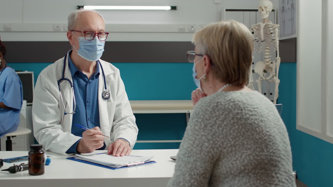 General practitioner attending consultation with senior patient
