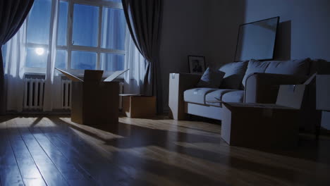 empty living room at night with moving boxes
