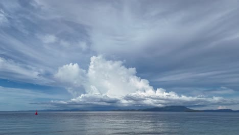 dramatic cloudscape over calm ocean with islands and ships