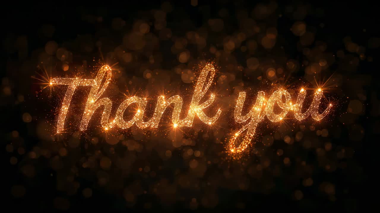 Zooming camera pulling gold cursive "Thank you" text closer at dark studio stage, revealing glitter