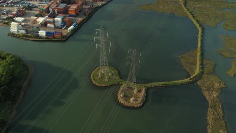 bird's eye view on pylons over the test river in eling, southampton, england, uk - aerial drone shot