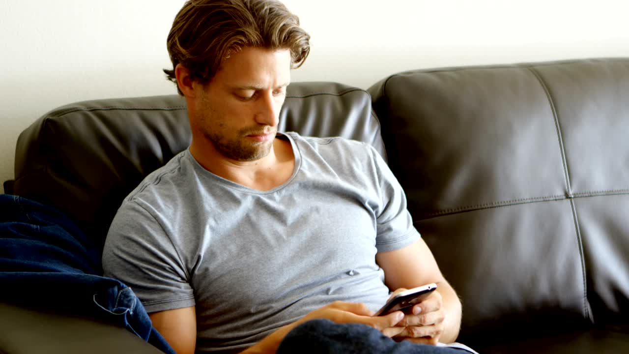 거실 4k에서 휴대 전화를 사용하는 남자