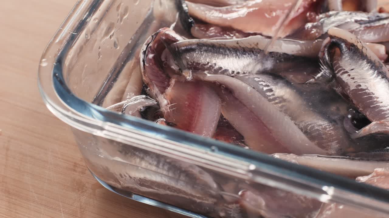 Fresh Sea sardines and Anchovy Fish and Mullus On Display On Ice On Market Store Shop. Seafood Fish Background, close up stand of small salty white fish.