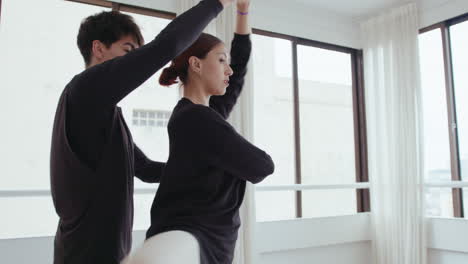 young ballet dancers practicing partnered pirouette in studio