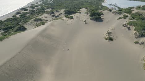 AERIAL:-Drone-shot-of-two-people-standing-in-the-sand-Dunes-of-Dominican-Republic