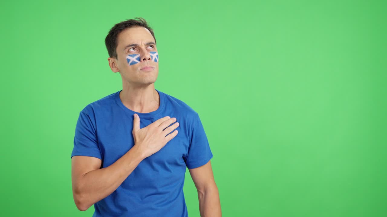 Man listening to the Scotland national anthem with solemnity