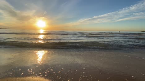 calming and relaxing gentle waves on a beach at sunrise in alicante, spain