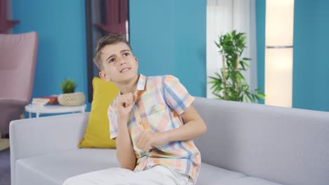 Cheerful-boy-is-dancing-on-the-sofa.