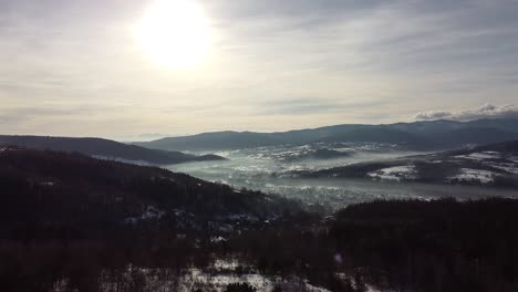 morning fog above small city seeing from drone