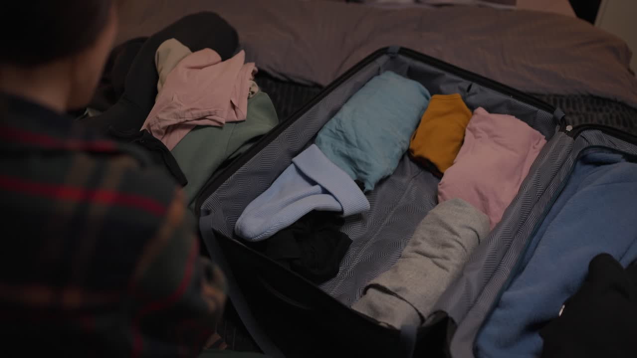 Packing a Suitcase with Clothes for Travel