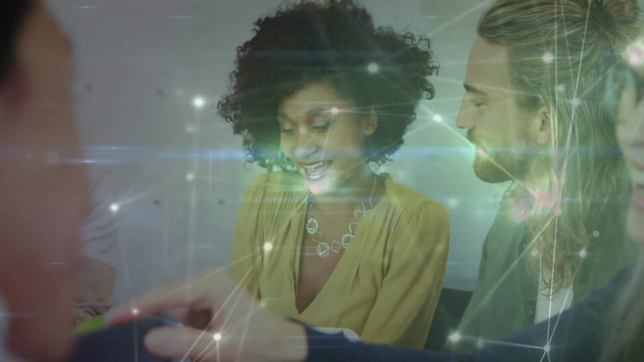 Colleagues collaborating around office table, integrating tech graphics with glowing network nodes