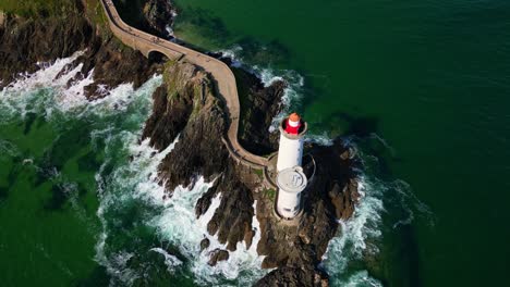 beautiful panoramic backwards drone movement over the petit minou lighthouse aka phare du petit minou in plouzané, finistère, brittany, france