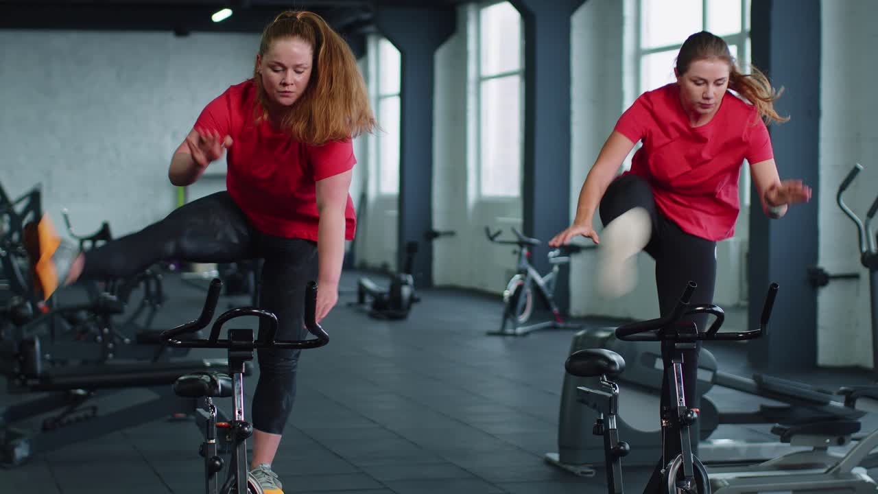 Group of girls performs aerobic training workout cardio routine on bike simulators cycle training