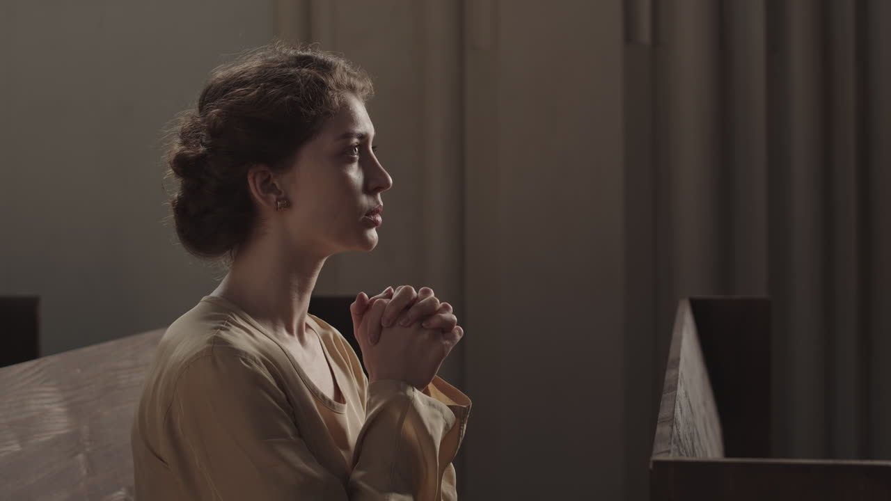 Young Caucasian Woman Praying in Church