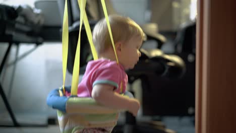 little child jumps with the help of special equipment for children