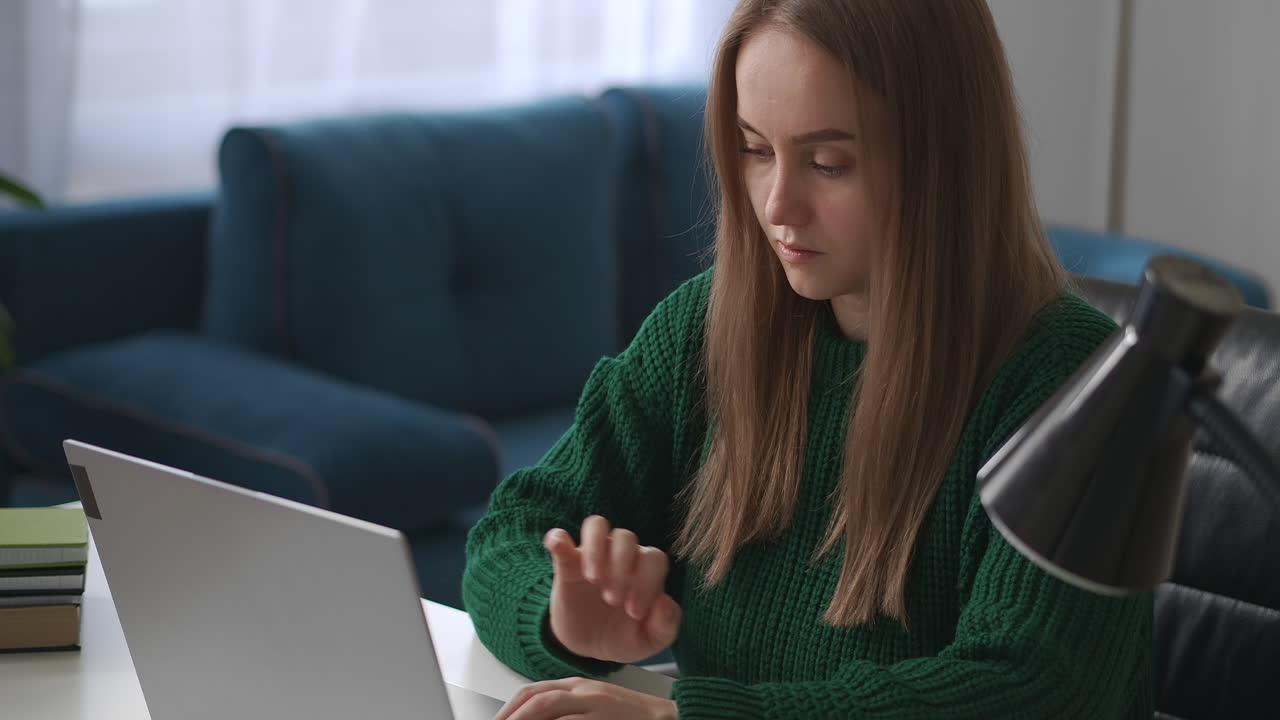 female programmer is working at home typing on keyboard of modern notebook remote online job for specialist woman in home office