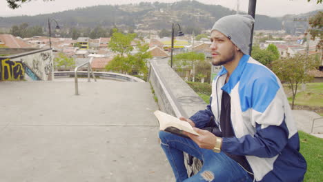 Young-boy-reading-a-book-on-the-street