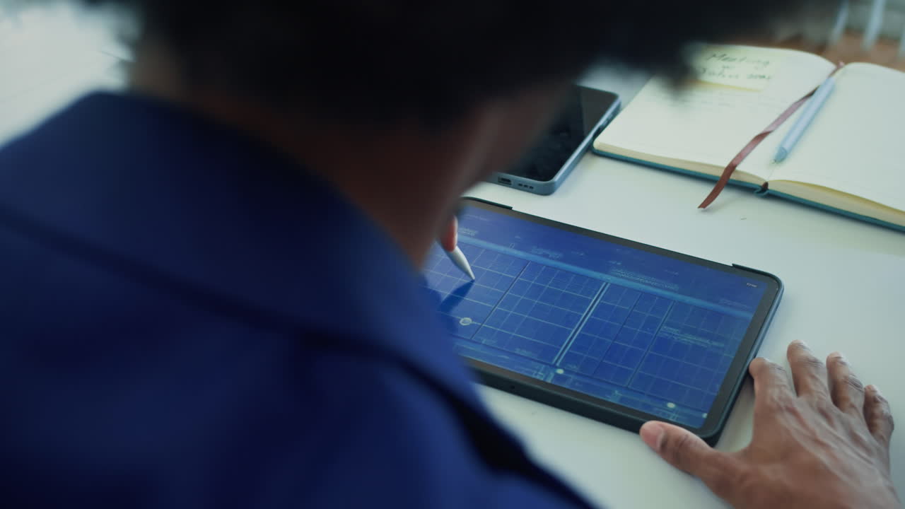 Architect Examining Scheme of Building on Tablet PC
