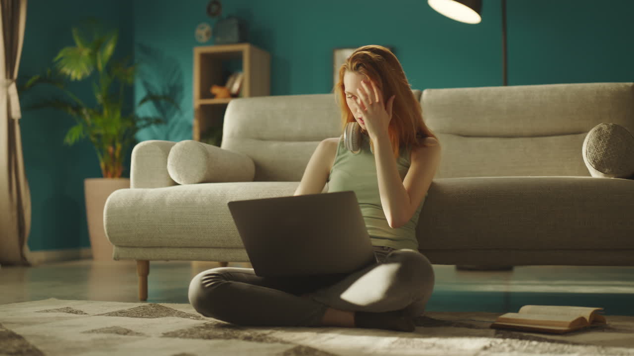Woman sitting on floor using laptop