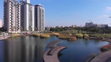 modern urban park with pond and residential high-rise buildings