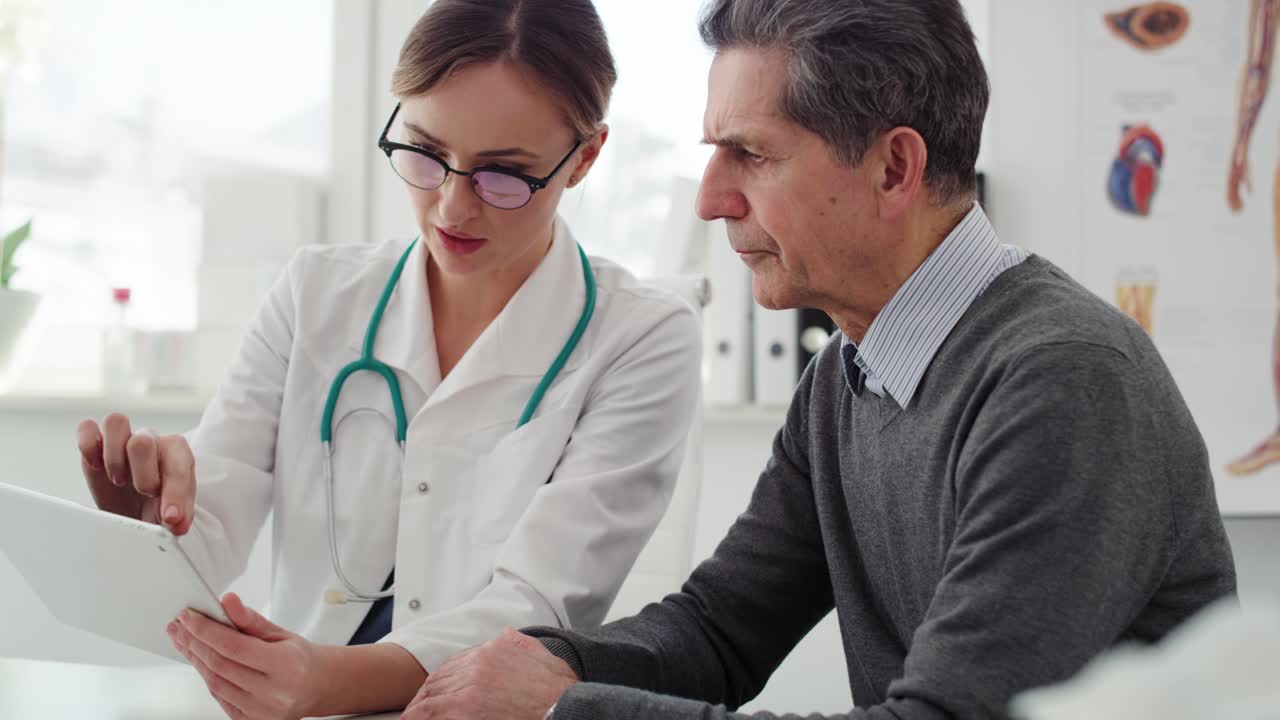 Handheld view of senior man having control visit in the doctor