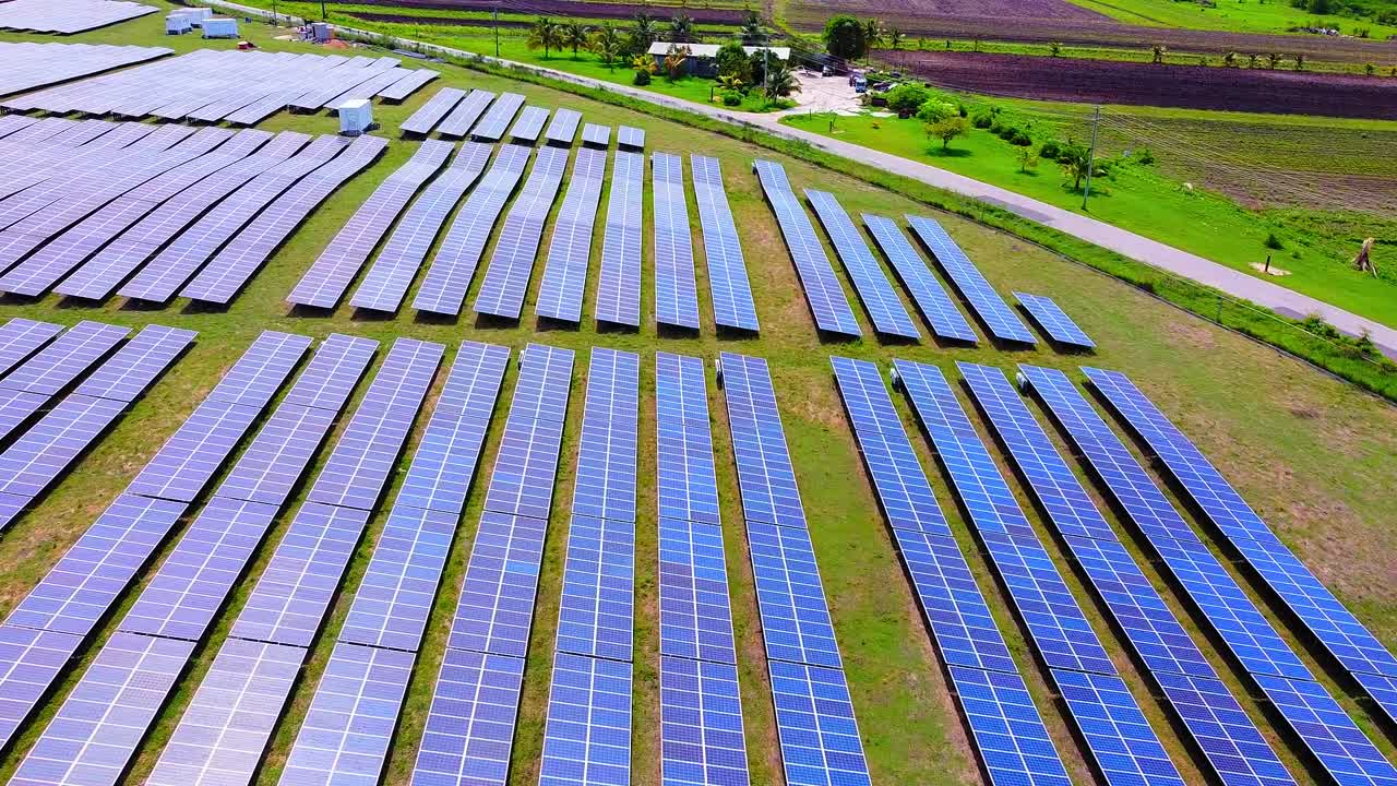 Ariel of a small Solar Panel farm with sunlight hitting the panels