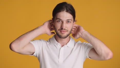 caucasian man in front of camera on yellow background.