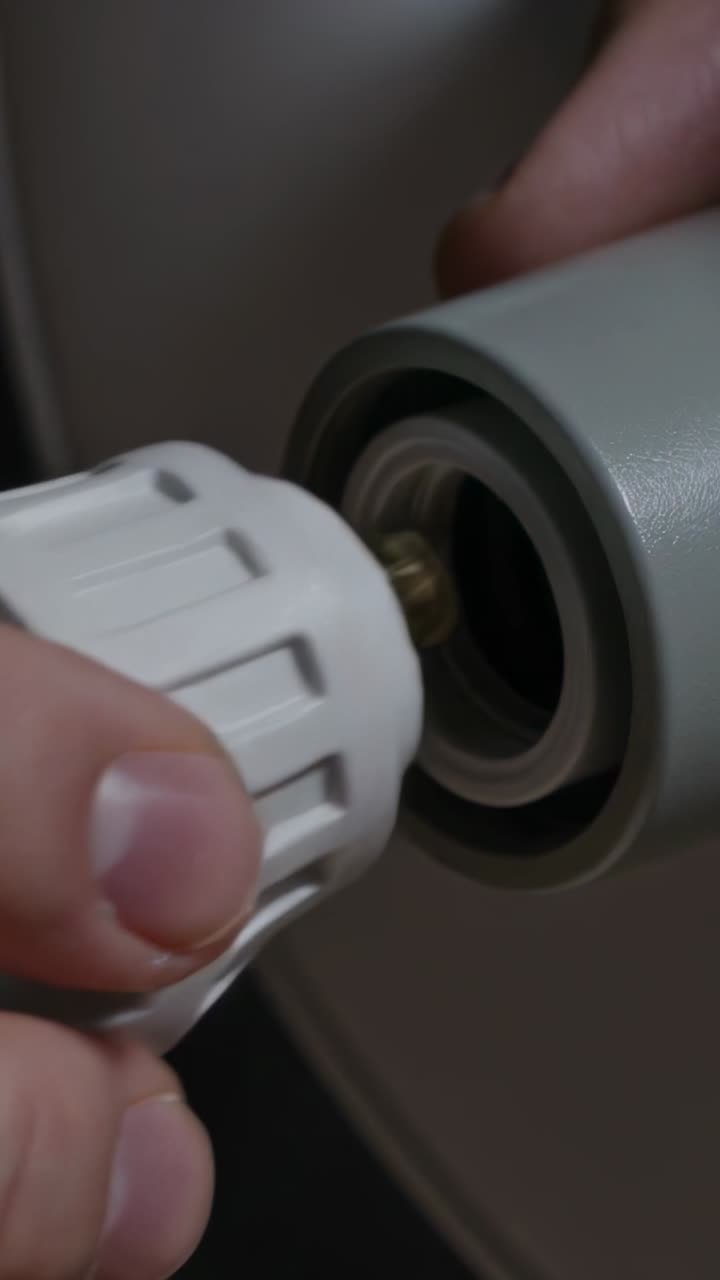 Vertical video: Removing halogen bulb for adapter, hands twisting at home, seating it into socket