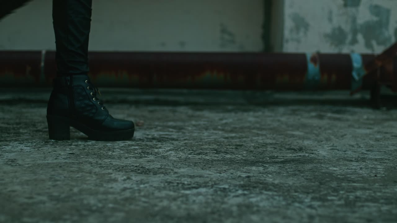 Woman walking on a rooftop in black boots