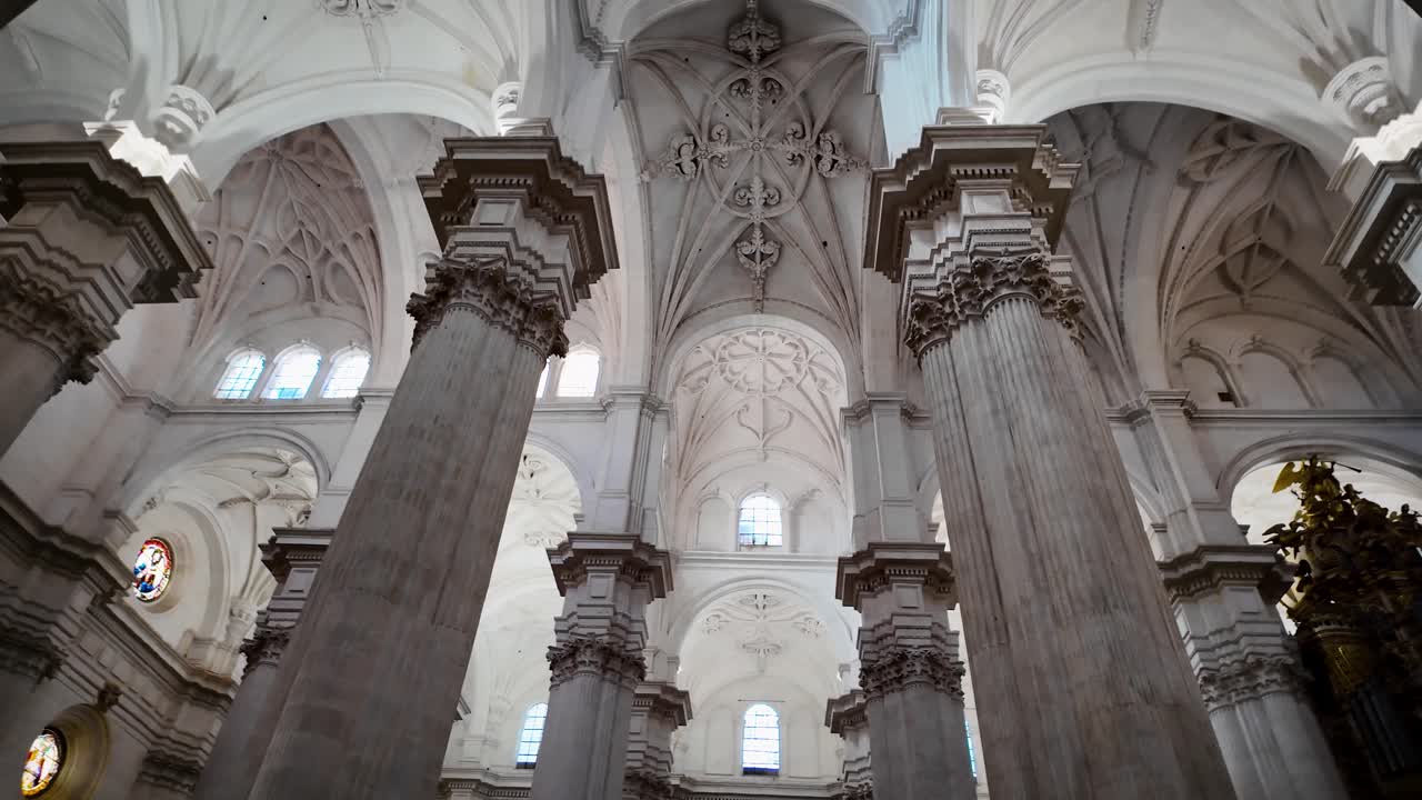 Panoramic video of the interior of Granada Cathedral, showcasing its towering columns, arches, naves, ribbed vaults, and the distinctive architectural spaces of this Spanish masterpiece