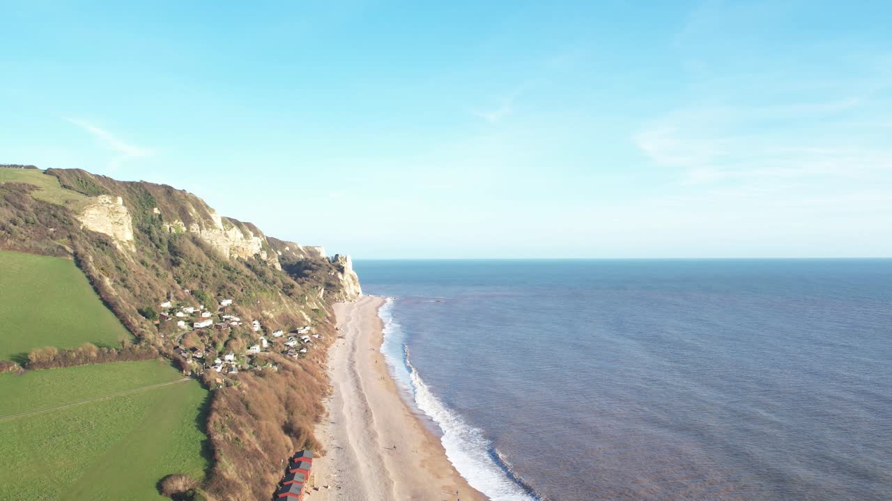 Aerial rising shot of Branscombe Beach and cliffs on a beautiful summers day