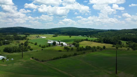 A-time-lapse-of-clouds-moving-over-the-rural-green-farmland-of-Lancaster-County,-Pennsylvania