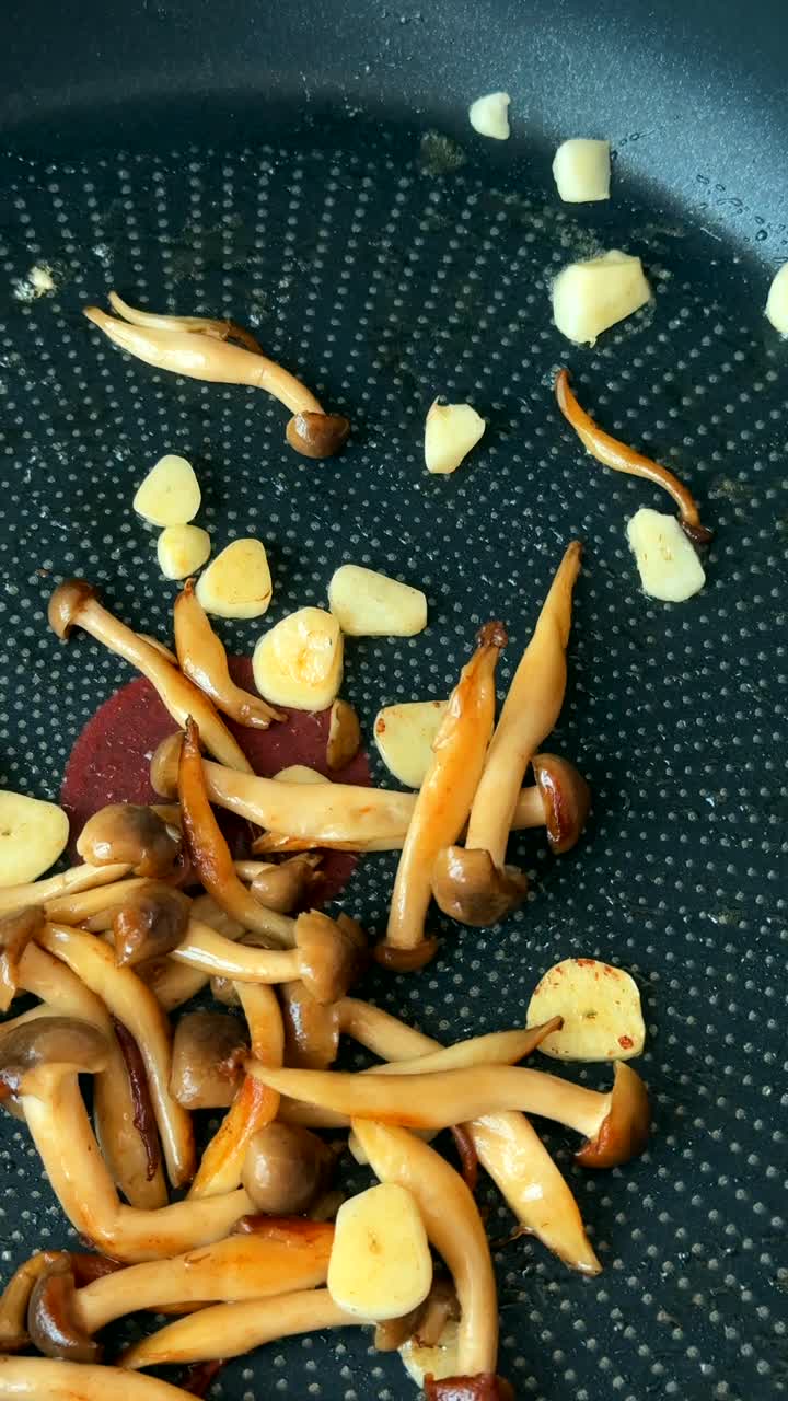 Frying Mushrooms with Garlic in a Pan